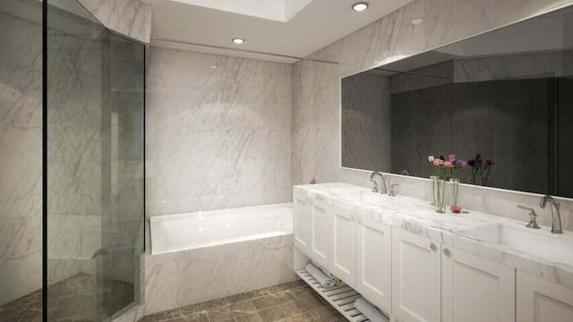 bathroom with vanity with extensive cabinet space, dual sinks, tile floors, and independent shower and bath