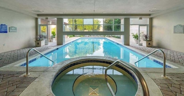 view of swimming pool featuring an indoor in ground hot tub