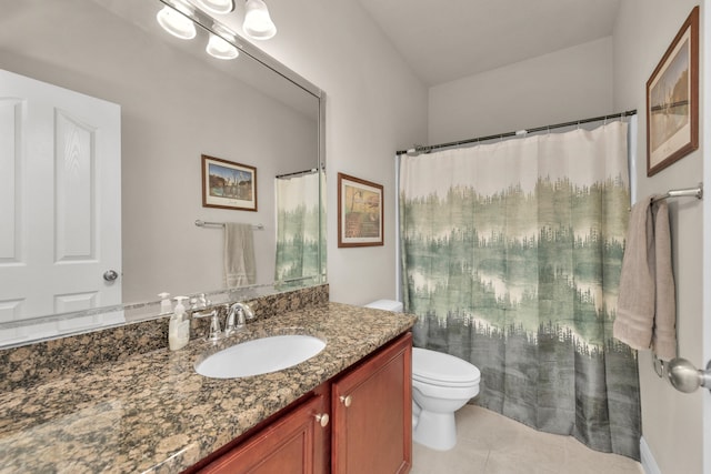 bathroom with tile flooring, vanity, and toilet