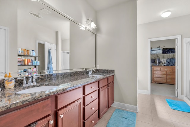 bathroom with double vanity and tile floors