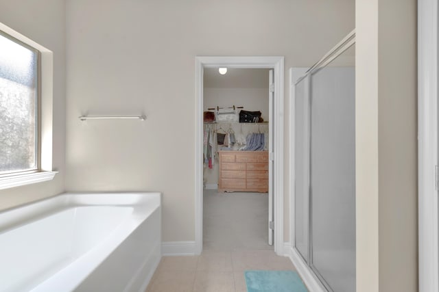 bathroom featuring plus walk in shower and tile flooring