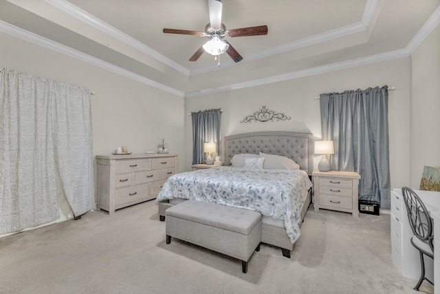 bedroom featuring light colored carpet, ceiling fan, crown molding, and a tray ceiling