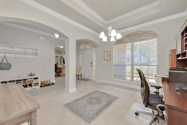 office space with a tray ceiling, light carpet, a chandelier, and crown molding