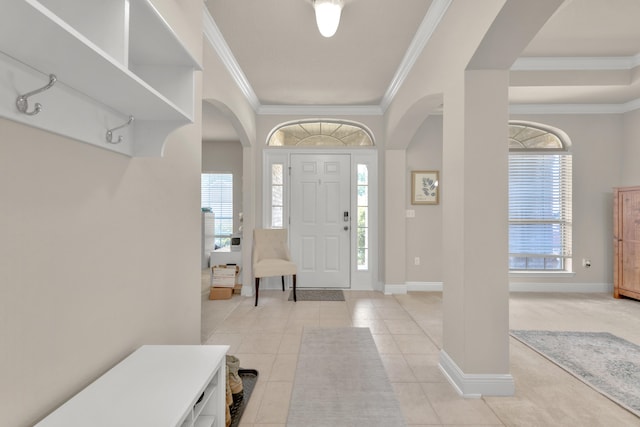 entryway with crown molding and light tile floors