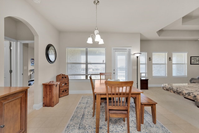 dining room with light tile flooring and a chandelier