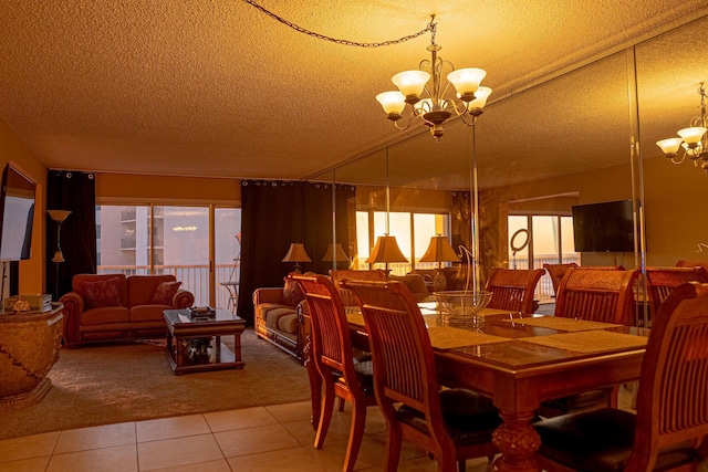 dining room with a textured ceiling, light tile floors, and a chandelier