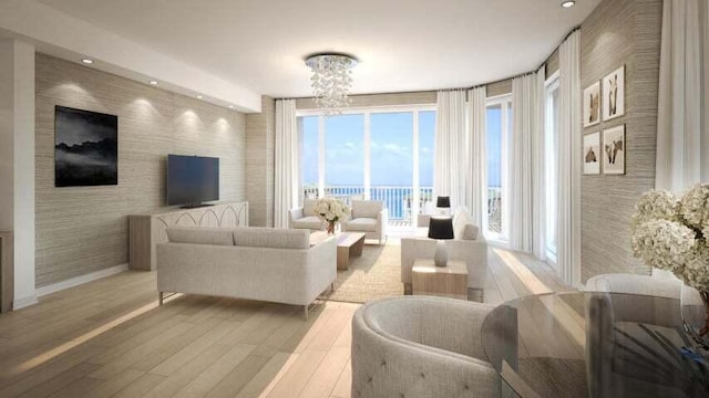 living room with a notable chandelier, a water view, and light wood-type flooring