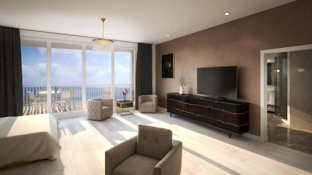 living room featuring a water view, floor to ceiling windows, and light wood-type flooring