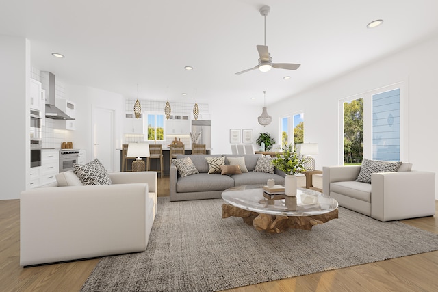 living room with light hardwood / wood-style flooring and ceiling fan