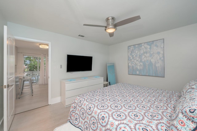 bedroom with light hardwood / wood-style floors and ceiling fan