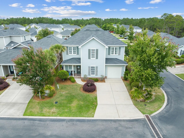 view of front of property featuring a garage and a front yard