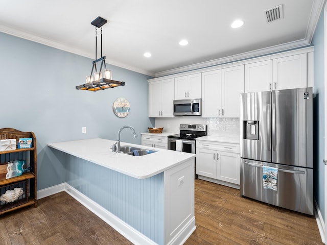 kitchen featuring pendant lighting, stainless steel appliances, dark wood-type flooring, and white cabinetry