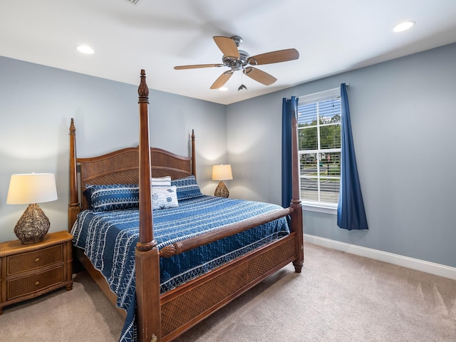 bedroom featuring light colored carpet and ceiling fan