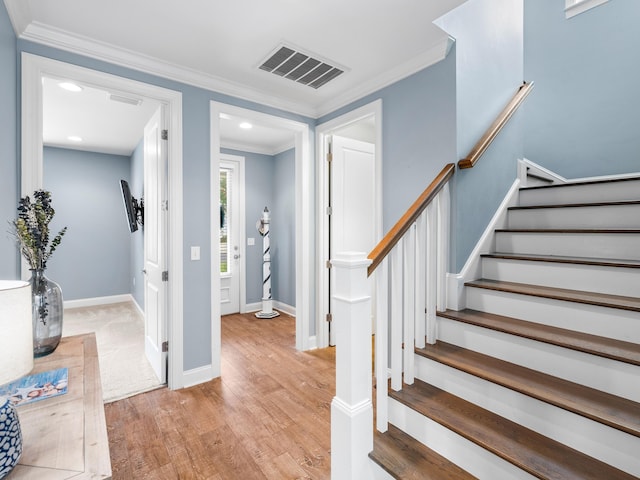 entrance foyer with light wood-type flooring and ornamental molding