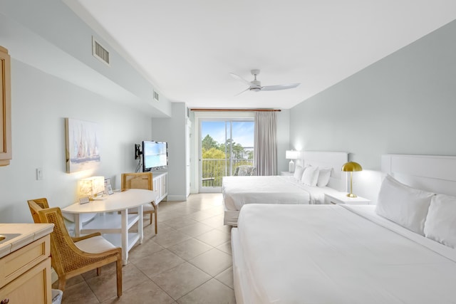 tiled bedroom featuring ceiling fan and access to outside