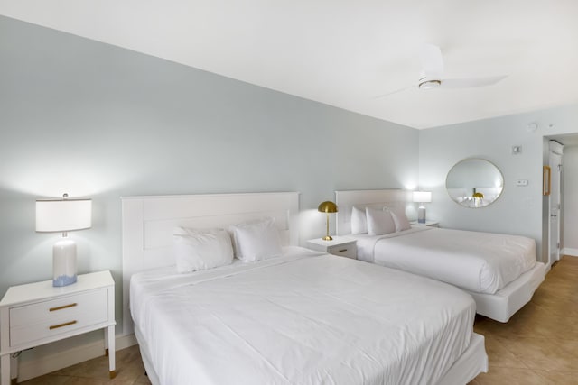 tiled bedroom with ceiling fan