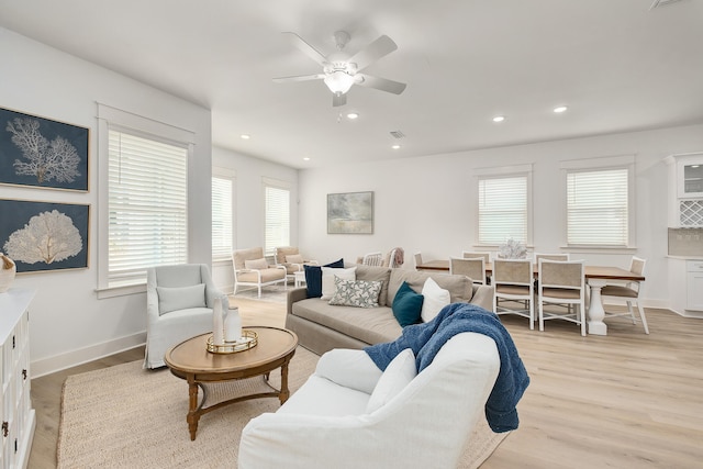 living room featuring light hardwood / wood-style floors and ceiling fan