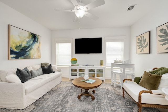 living room featuring hardwood / wood-style floors and ceiling fan