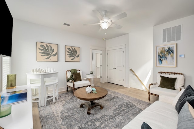 living room featuring ceiling fan and light wood-type flooring