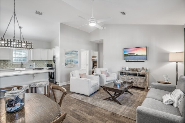 living room featuring high vaulted ceiling, sink, ceiling fan, and hardwood / wood-style flooring