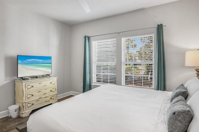 bedroom with ceiling fan and dark hardwood / wood-style floors