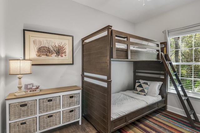 bedroom with dark hardwood / wood-style floors