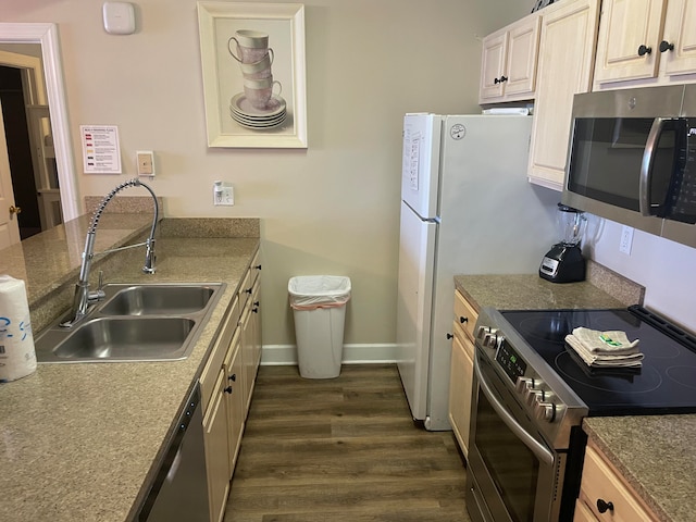 kitchen with stainless steel appliances, dark hardwood / wood-style floors, and sink