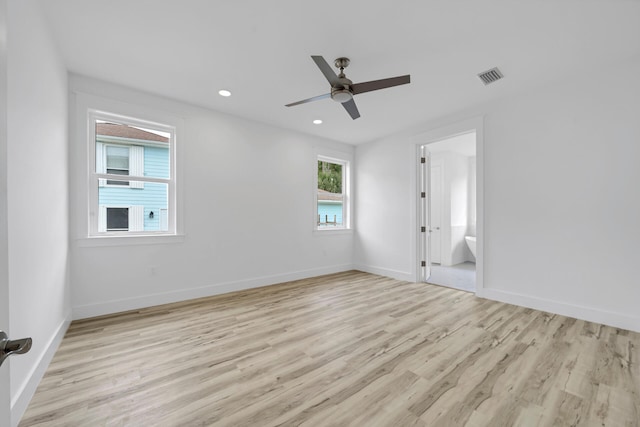 spare room featuring light wood finished floors, recessed lighting, visible vents, a ceiling fan, and baseboards