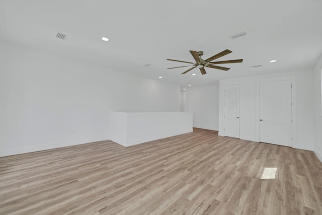 unfurnished room with ceiling fan and light wood-type flooring