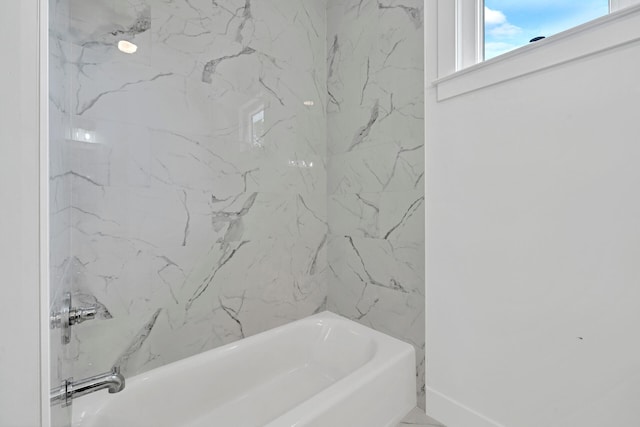 full bath with baseboards and shower / bathtub combination