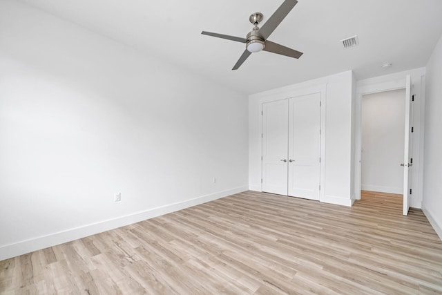 unfurnished bedroom featuring light wood finished floors, baseboards, and visible vents