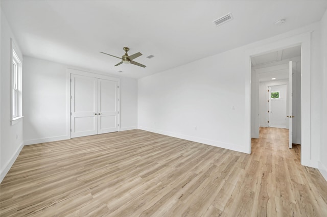 unfurnished bedroom with ceiling fan and light wood-type flooring