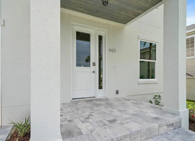 property entrance featuring a patio area and stucco siding