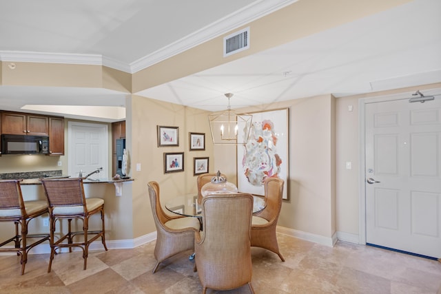 dining space with an inviting chandelier and ornamental molding