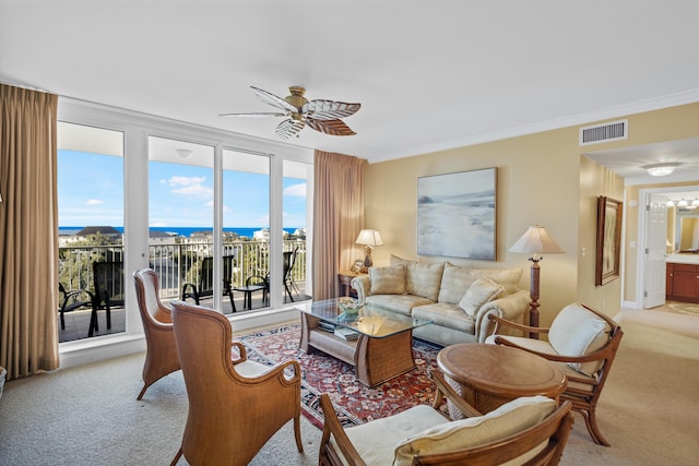 carpeted living room featuring ceiling fan, a water view, and ornamental molding