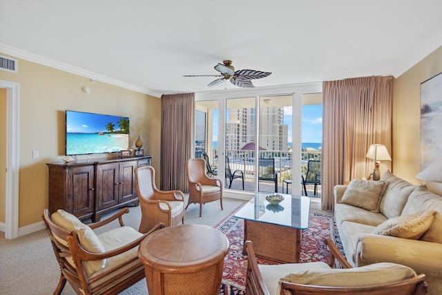 carpeted living room featuring ceiling fan and crown molding