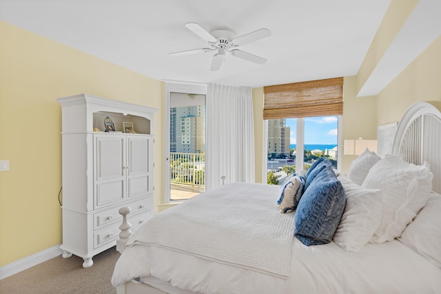 bedroom with access to exterior, light colored carpet, and ceiling fan