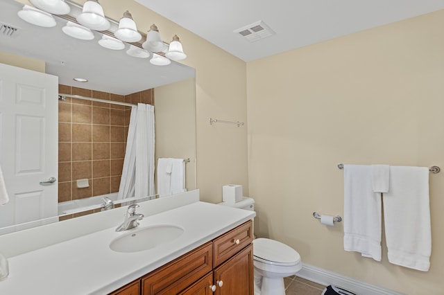 bathroom featuring toilet, vanity, and tile patterned floors