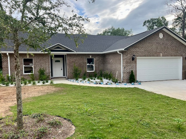 ranch-style home featuring a garage and a front lawn