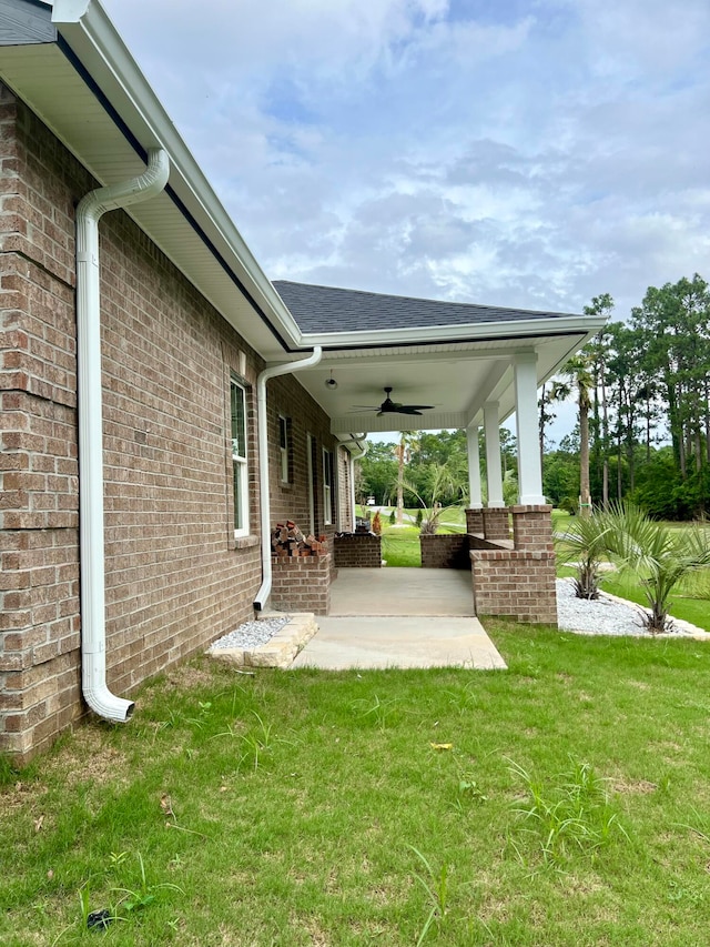 view of yard with ceiling fan and a patio area