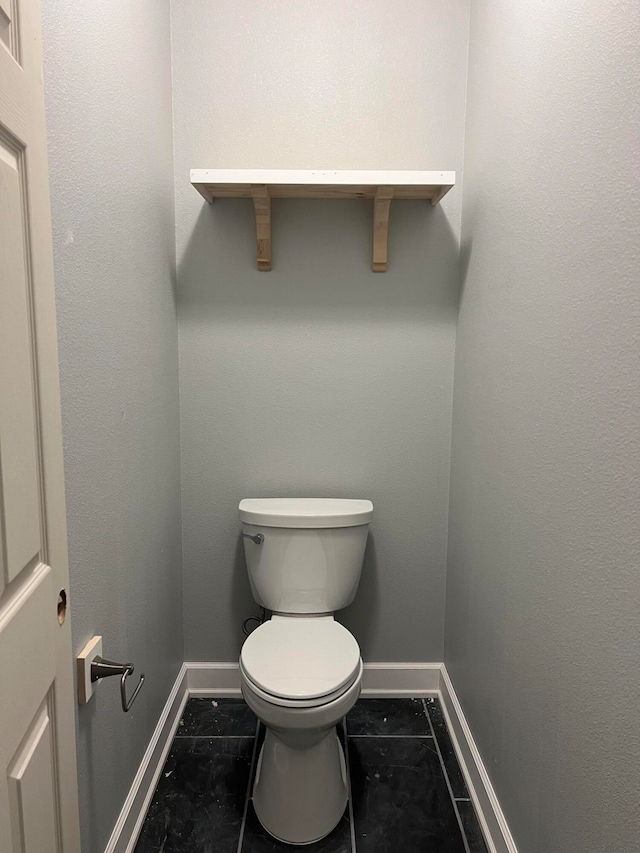 bathroom featuring toilet and tile patterned floors