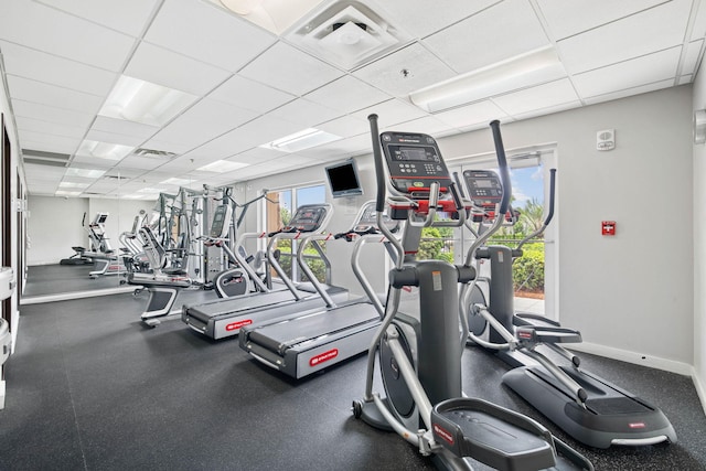 gym with a paneled ceiling