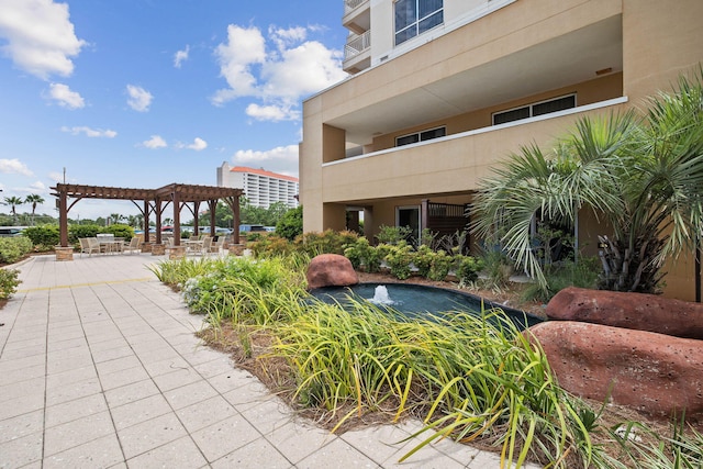 view of community with a patio area and a pergola