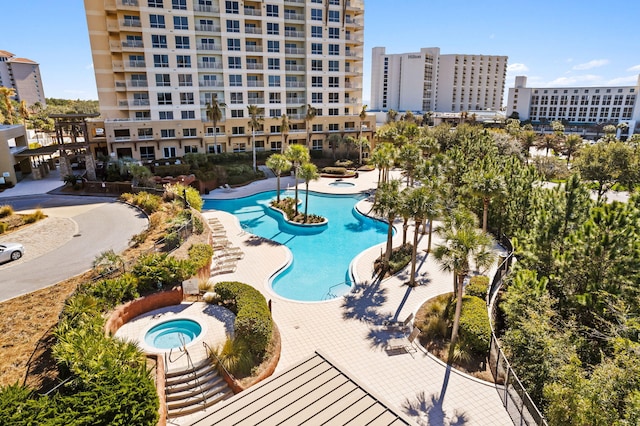 view of swimming pool featuring a community hot tub and a patio