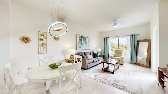 living room featuring light wood-type flooring and ceiling fan