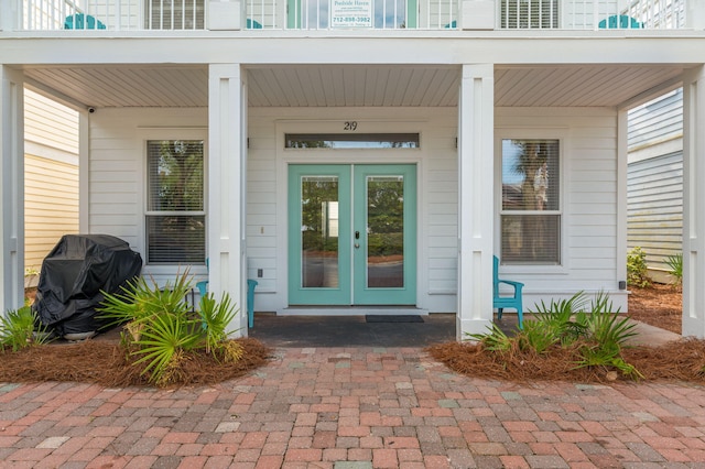 doorway to property with french doors and a porch