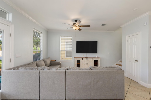 unfurnished living room featuring ornamental molding, ceiling fan, and light tile floors