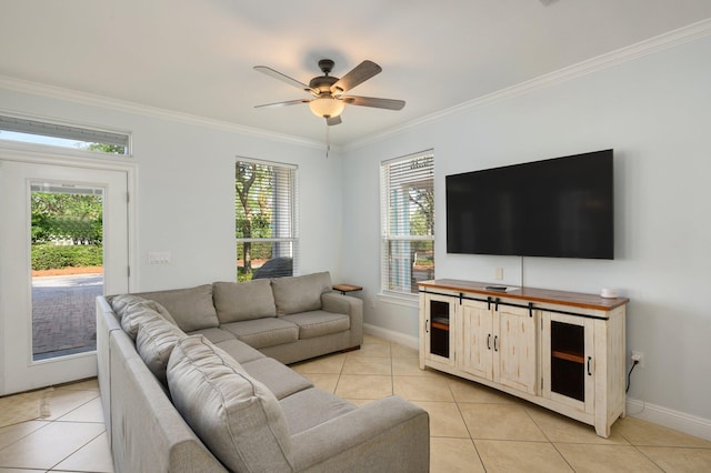 living room featuring plenty of natural light, ceiling fan, crown molding, and light tile floors