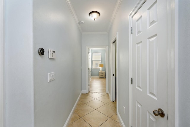 hall featuring crown molding and light tile floors