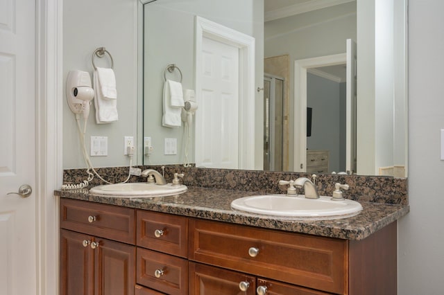 bathroom with crown molding, vanity with extensive cabinet space, and dual sinks